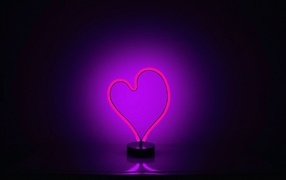 Glowing heart on purple background