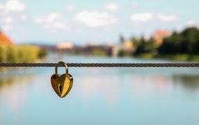 Heart hanging on a rope on a bridge