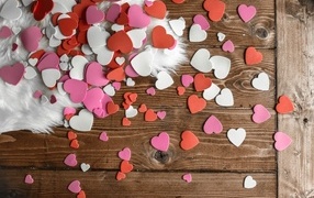 Lots of paper hearts on a wooden floor