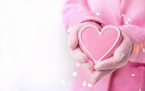 Pink sweet heart in hands