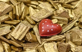 Red heart on golden chips