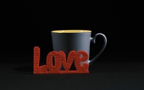 Red inscription love with a cup of coffee