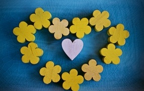 Wooden flowers and a heart on a blue background