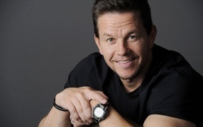 Smiling Mark Wahlberg with a watch on his wrist