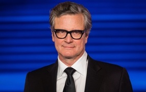 Stylish actor Colin Firth on a blue background