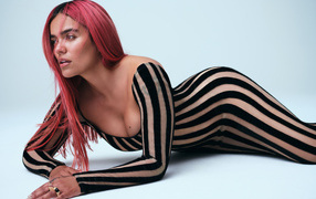 Колумбийская певица Karol G в полосатом платье