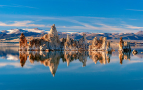 Sharp rocks reflected in the still water of the lake