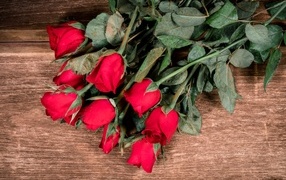 Букет красных английских роз на деревянном столе