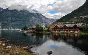 Beautiful houses near a mountain lake under a beautiful sky