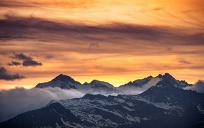 Beautiful sunset in the sky over snow-capped mountains