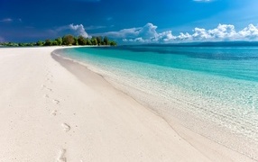 Beautiful blue water of the ocean on the shore with white sand