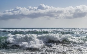 Big white cloud over the stormy sea