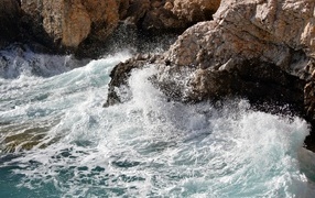 Raging sea waves hit the rocks