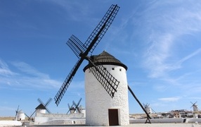 Old white windmill under blue sky