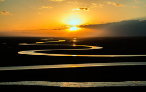 Winding river in the sun at sunset