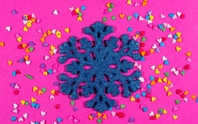 Big blue snowflake on a pink background with hearts