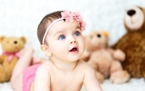 Girl with blue eyes on the background of toys