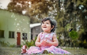 Little girl enjoys soap bubbles
