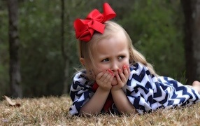 Little girl with a red bow on her head
