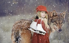 Little girl with a wolf in winter