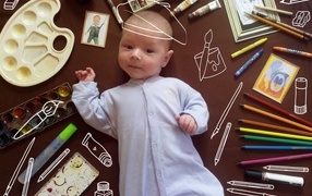 Новорожденный ребенок с канцелярскими предметами