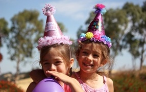 Two little cheerful girls celebrating a birthday