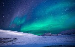 Beautiful aurora borealis over the snow-covered shore
