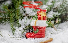 Christmas tree decoration in the snow with a branch