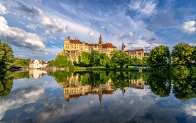 Hohenzollern Castle reflected in the water in summer, Germany