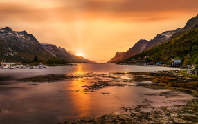 Bright sun in the mountains over the bay, Norway