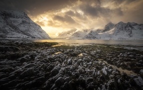 Icy shore of a bay in the mountains, Lofoten Islands Norway