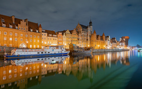 Houses are reflected in the water channel, the city of Gdansk. Poland