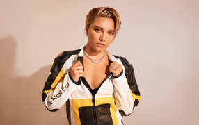 Actress Florence Pugh in a sports jacket on a pink background