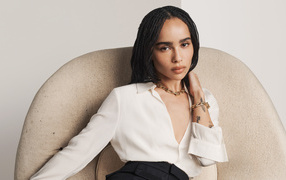 Actress Zoe Kravitz in a white shirt sits in a chair