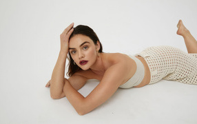 American actress Lucy Hale lies on the floor