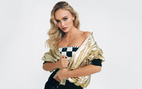 Beautiful blonde Lily-Rose Depp in a jacket on a white background