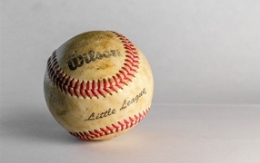 Old baseball on gray background