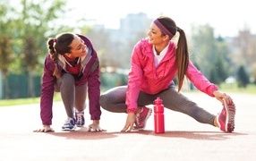 Two sports girls doing stretching
