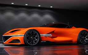 Быстрый оранжевый автомобиль Genesis X Gran Berlinetta вид сбоку
