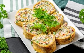 Рулет с омлета с начинкой на тарелке