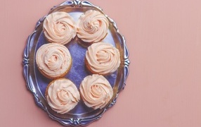 Cupcakes with pink cream on the table