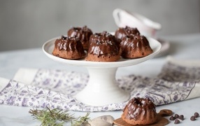 Muffins with chocolate icing on the table