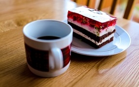 Кусок торта с чашкой кофе на деревянном столе