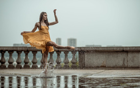 Девушка балерина идет по луже