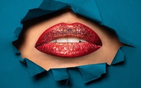 Woman's lips with red lipstick in glitter