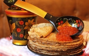 Large wooden spoon with caviar and pancakes for Maslenitsa