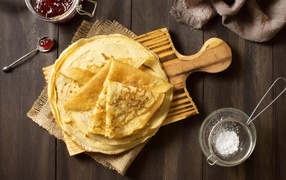Thin pancakes with powdered sugar for Maslenitsa