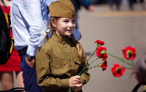 Little girl with carnations for Victory Day on May 9