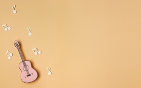 Бумажная гитара и ноты на бежевом фоне