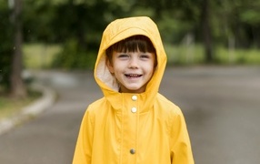 Улыбающийся мальчик в желтой куртке